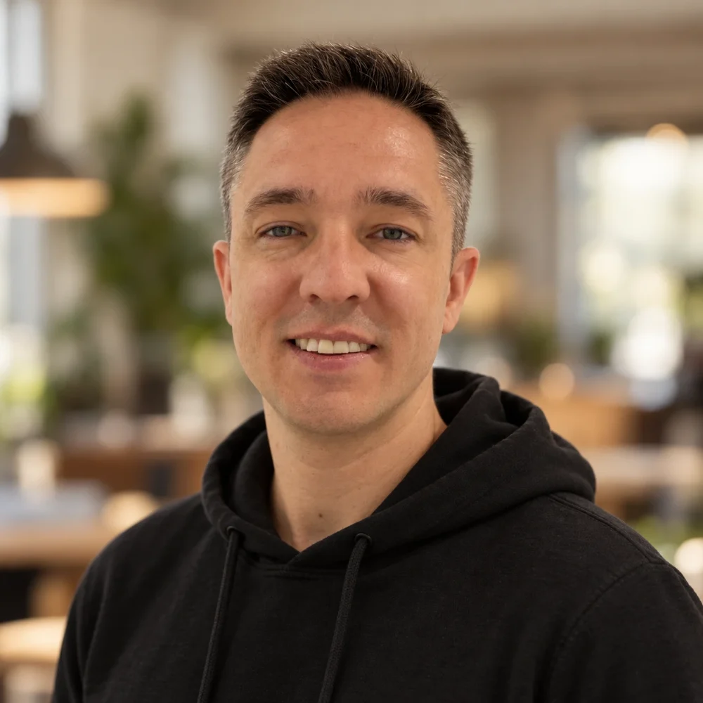 Lee Chapman, smiling, in a black hoodie